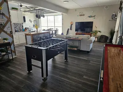 a living room with a large table in the middle of a room at Hidden Gem Guest House in Panama City Beach