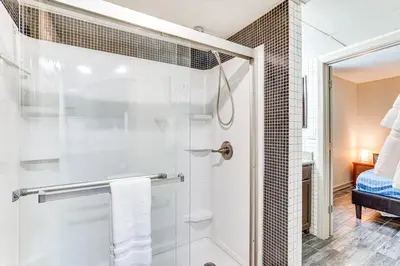 a bathroom with a shower with a glass door at Beachfront Panama City Condo with Balcony and Views! in Panama City Beach