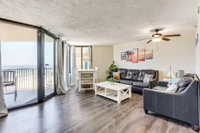 a living room with a couch and a table at Beachfront Panama City Condo with Balcony and Views! in Panama City Beach