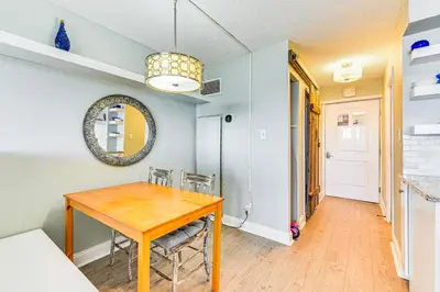a dining room with a wooden table and chairs at PCB Coastal Condo with On-Site Beach Access! in Panama City Beach