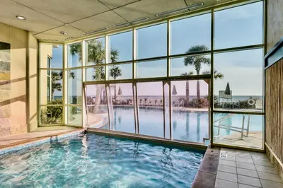 a large indoor swimming pool with a large window at AQUA RESORT! Beachfront, 3 Bedroom Condo! 2 Bedrooms Beach Front! Sleeps 7! Free Beach Chairs by Dolce Vita Getaways PCB in Panama City Beach