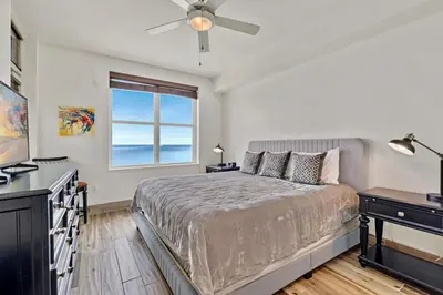a bedroom with a bed and a window at AQUA RESORT! Beachfront, 3 Bedroom Condo! 2 Bedrooms Beach Front! Sleeps 7! Free Beach Chairs by Dolce Vita Getaways PCB in Panama City Beach