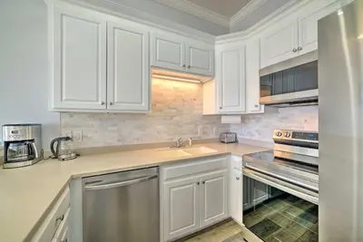 a kitchen with white cabinets and a sink at Sunny PCB Home with Balcony Steps to the Beach! in Panama City Beach