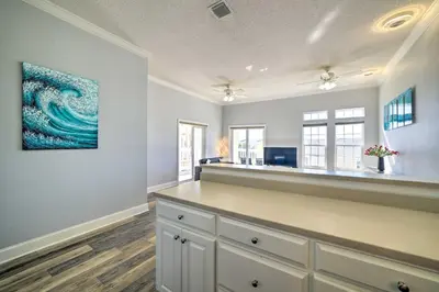 a home office with a painting on the wall at Sunny PCB Home with Balcony Steps to the Beach! in Panama City Beach