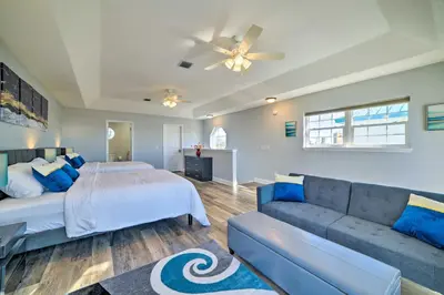 a living room with a bed and a couch at Sunny PCB Home with Balcony Steps to the Beach! in Panama City Beach