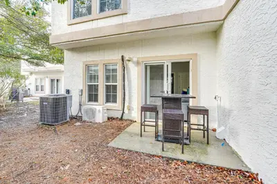 a group of chairs sitting outside of a house at Renovated PCB Studio, 2 Min Walk To Laguna Beach! in Panama City Beach