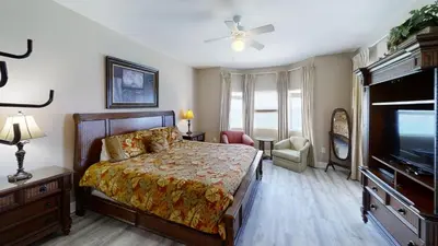 a bedroom with a bed and a flat screen tv at Tidewater 1102 in Panama City Beach