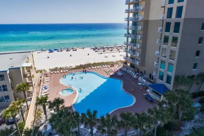 a view of the beach from the balcony of a resort at Tidewater 1102 in Panama City Beach