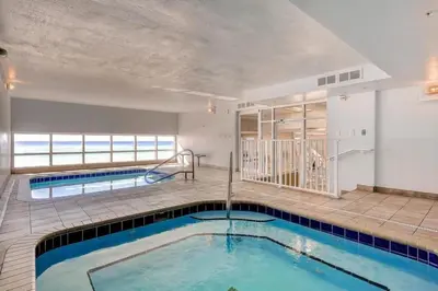 a swimming pool in the middle of a building at Tidewater 704 in Panama City Beach