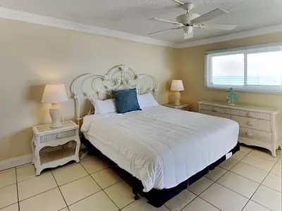 a bedroom with a large white bed with two night stands at Regency Towers 505 in Panama City Beach