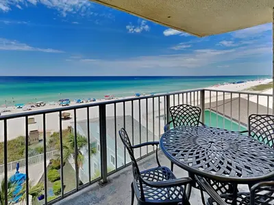 a balcony with a table and chairs and the beach at Regency Towers 505 in Panama City Beach