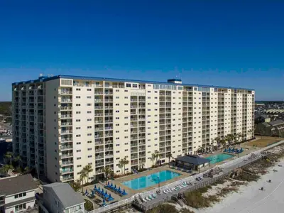 a large white apartment building with a swimming pool at Regency Towers Panama City Beach #719 in Panama City Beach