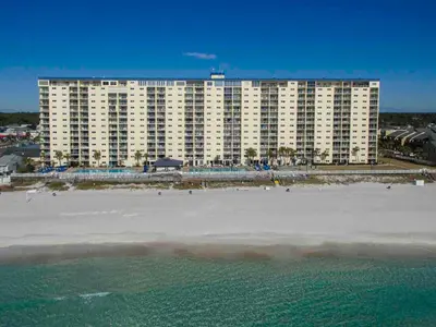 a large building on the beach next to the ocean at Regency Towers Panama City Beach #719 in Panama City Beach