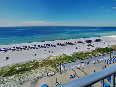 a view of a beach with chairs and the ocean at Regency Towers Panama City Beach #719 in Panama City Beach