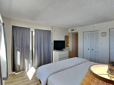 a bedroom with a large bed and a television at Regency Towers Panama City Beach #719 in Panama City Beach