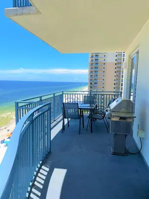 a balcony with a table and chairs and the ocean at Sterling Breeze 1007 in Panama City Beach