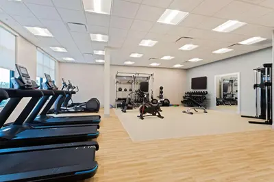 a gym with treadmills and elliptical machines at Homewood Suites By Hilton Panama City Beach, Fl in Panama City Beach
