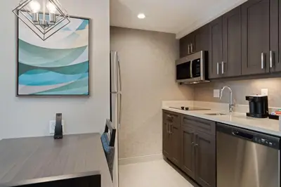 a kitchen with a sink and a refrigerator at Homewood Suites By Hilton Panama City Beach, Fl in Panama City Beach