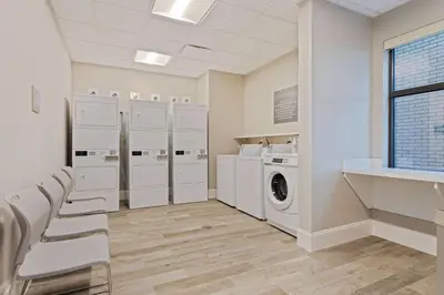 a laundry room with white appliances and a washer and dryer at Homewood Suites By Hilton Panama City Beach, Fl in Panama City Beach