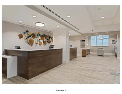 a lobby with a waiting area with a smile sign on the wall at Homewood Suites By Hilton Panama City Beach, Fl in Panama City Beach
