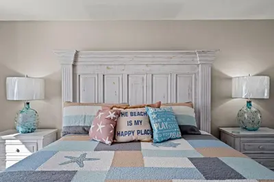 a bedroom with a bed with pillows on it at Emerald Beach #1330 by Book That Condo in Panama City Beach