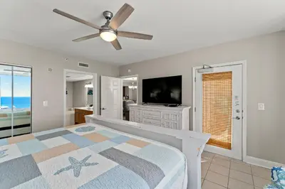 a bedroom with a bed and a flat screen tv at Emerald Beach #1330 by Book That Condo in Panama City Beach