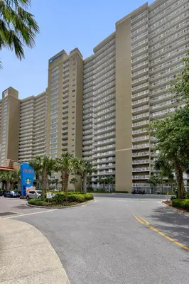 a large building with a parking lot in front of it at Emerald Beach #1330 by Book That Condo in Panama City Beach