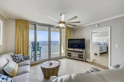a living room with a couch and a flat screen tv at Emerald Beach #1330 by Book That Condo in Panama City Beach