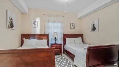 a bedroom with two beds and a window at Ocean Villa 305 by Sand Seeker Vacations in Panama City Beach