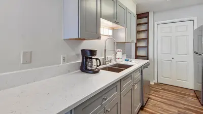 a kitchen with a counter with a coffee maker on it at The Shell Shack #3 by Sand Seeker Vacations in Panama City Beach