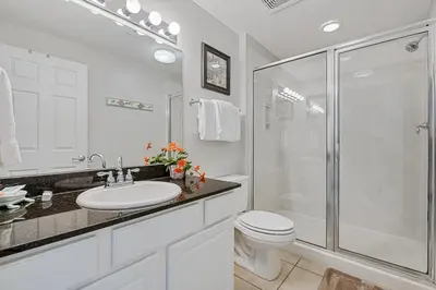 a bathroom with a shower and a toilet and a sink at Calypso Resort Beachfront Condo in Panama City Beach