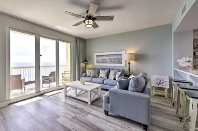 a living room with a couch and a table at Panama City Beach Condo with Free Beach Service! in Panama City Beach