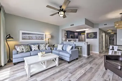 a living room with a couch and a table at Panama City Beach Condo with Free Beach Service! in Panama City Beach