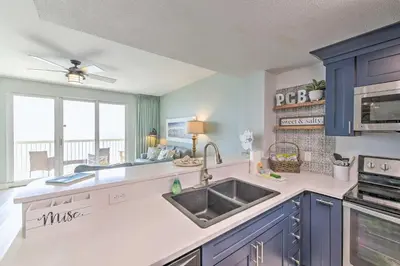 a kitchen with blue cabinets and a sink at Panama City Beach Condo with Free Beach Service! in Panama City Beach