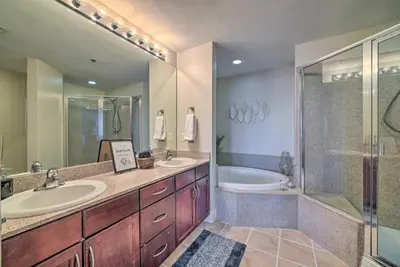 a bathroom with two sinks and a shower and a tub at Lagoon-View Balcony! Family Resort Escape in PCB in Panama City Beach
