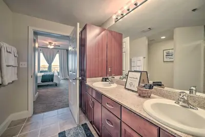 a bathroom with two sinks and a large mirror at Lagoon-View Balcony! Family Resort Escape in PCB in Panama City Beach