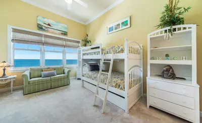 a bedroom with two bunk beds and a couch at En Soleil #1522 West in Panama City Beach