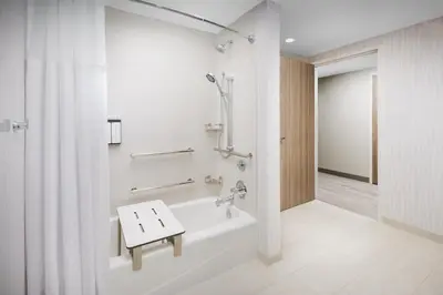 a bathroom with a tub and a shower and a sink at Hyatt Place Panama City Beach - Beachfront in Panama City Beach