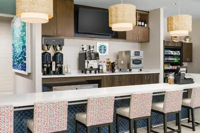 a bar with chairs and a coffee station at Hyatt Place Panama City Beach - Beachfront in Panama City Beach
