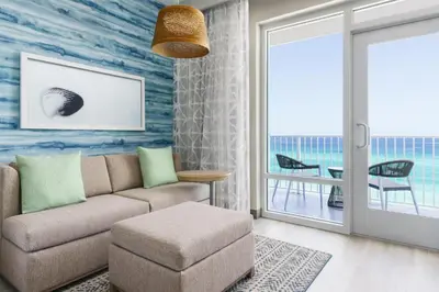 a living room with a couch and a table at Hyatt Place Panama City Beach - Beachfront in Panama City Beach