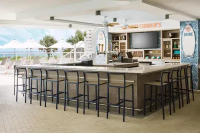 a bar with bar stools at a beach resort at Hyatt Place Panama City Beach - Beachfront in Panama City Beach