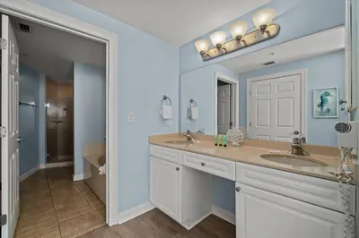 a bathroom with two sinks and a mirror at Boardwalk Beach Resort #1403 by Book That Condo in Panama City Beach