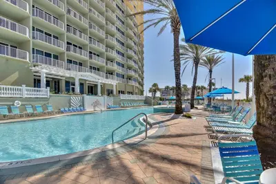 a swimming pool at a resort with chairs and a hotel at Boardwalk Beach Resort #1403 by Book That Condo in Panama City Beach