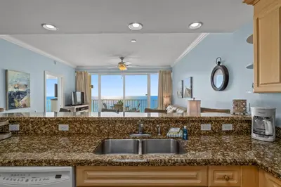 a kitchen with a sink and a view of the ocean at Boardwalk Beach Resort #1403 by Book That Condo in Panama City Beach