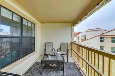 a balcony with a table and two chairs at Cozy PCB Condo Less Than half Mile to Public Beach Access! in Panama City Beach