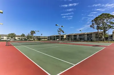 a tennis court with two tennis courts at Panama City Beach Townhome - Walk to Beach! in Panama City Beach