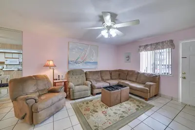 a living room with couches and a ceiling fan at Panama City Beach Townhome - Walk to Beach! in Panama City Beach