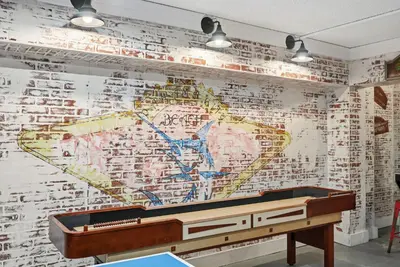 a mural of a map on a wall with a piano at Top Of The Gulf 621 in Panama City Beach