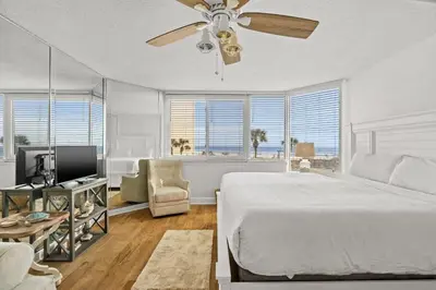a bedroom with a bed and a ceiling fan at Top of The Gulf 213 in Panama City Beach