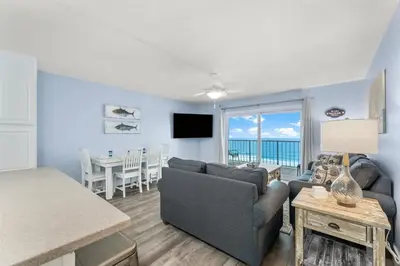 a living room with a couch and a table at The Summit 1031 in Panama City Beach